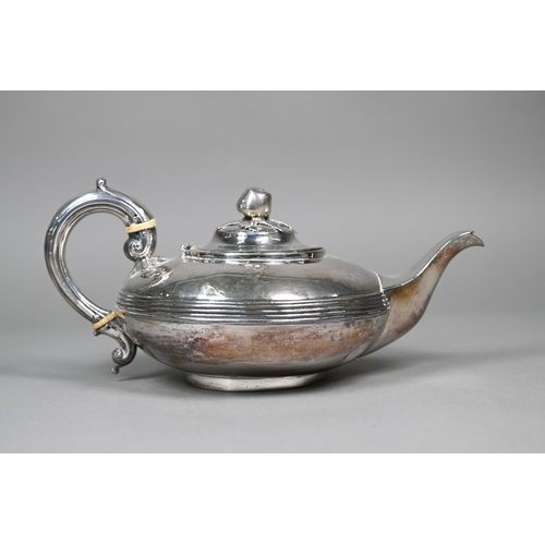 50 - A Victorian silver teapot of compressed form with apple finial, reeded waist and scroll handle with ... 