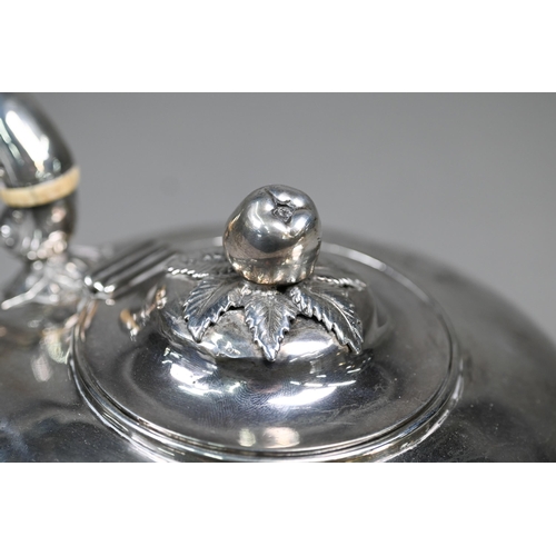 50 - A Victorian silver teapot of compressed form with apple finial, reeded waist and scroll handle with ... 