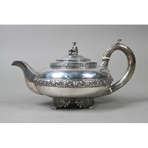 55 - A George IV silver teapot in the Regency taste, the finial cast as a seated Eastern figure, above ch... 