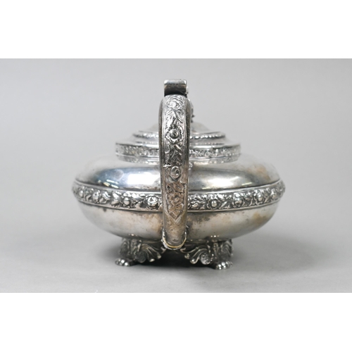 55 - A George IV silver teapot in the Regency taste, the finial cast as a seated Eastern figure, above ch... 