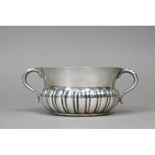 58 - A heavy quality silver porringer with half-reeded body and twin scroll handles, Edward Barnard &... 