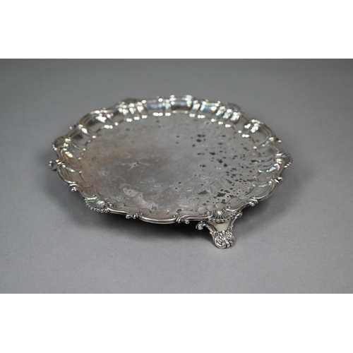 59 - An early Victorian silver salver with engraved decoration and moulded, shell and scroll rim, on scro... 