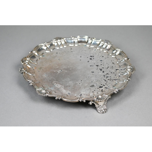 59 - An early Victorian silver salver with engraved decoration and moulded, shell and scroll rim, on scro... 