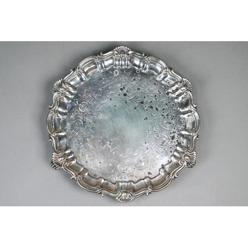 59 - An early Victorian silver salver with engraved decoration and moulded, shell and scroll rim, on scro... 