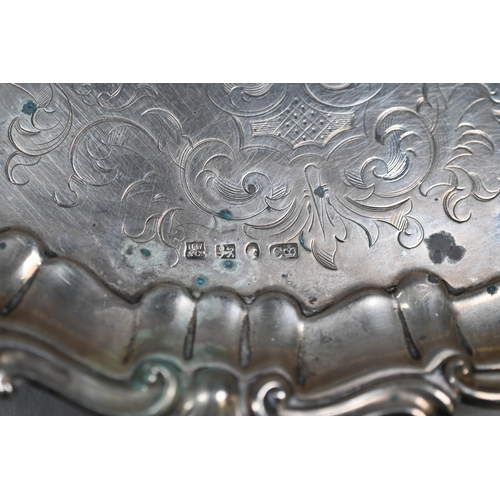 59 - An early Victorian silver salver with engraved decoration and moulded, shell and scroll rim, on scro... 