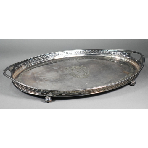 6 - A large Edwardian Regency Revival epns oval tray with pierced rim and engraved decoration, on bun fe... 