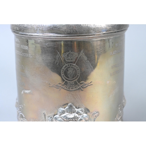 60 - Military interest: a heavy quality Victorian silver peg tankard, the hinged cover with lion and glob... 