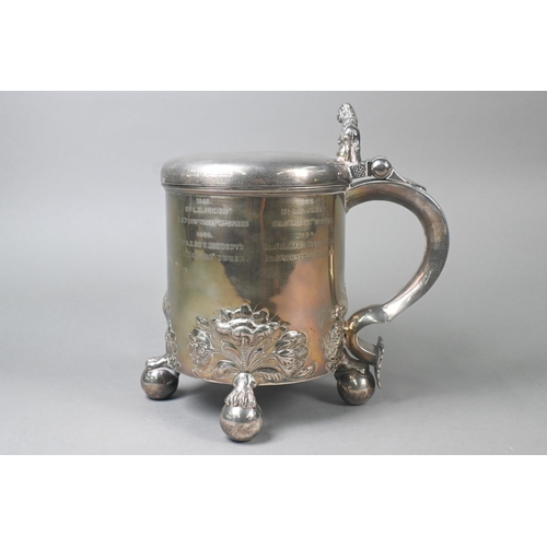 60 - Military interest: a heavy quality Victorian silver peg tankard, the hinged cover with lion and glob... 