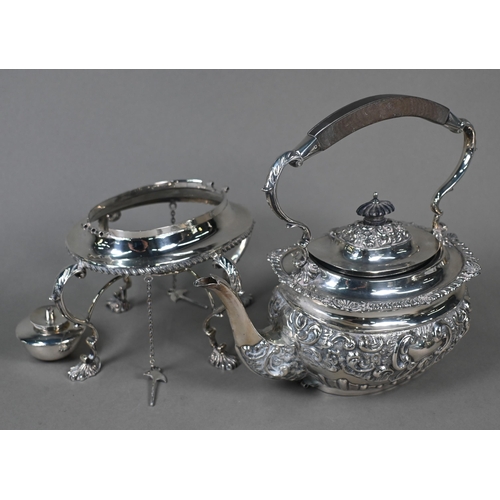 63 - An Edwardian silver four-piece tea service including kettle on stand, with embossed and chased decor... 