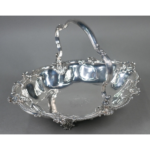 Garrards: a very heavy quality George IV silver fruit basket with scrolling swing handle and lobed body with gadroon and scroll rim, on four scalloped bracket supports, Robert Garrard II, London 1829, approx 75.5oz, 40.5cm long