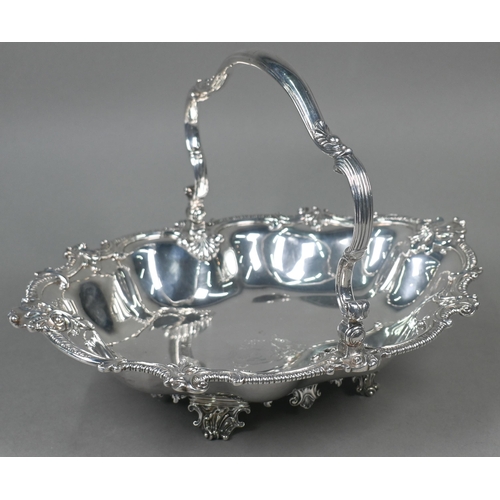 65 - Garrards: a very heavy quality George IV silver fruit basket with scrolling swing handle and lobed b... 