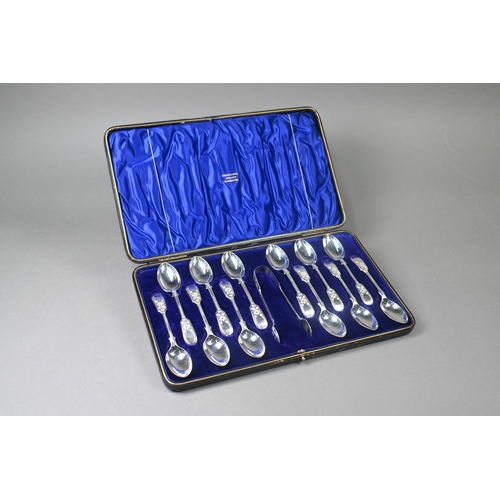 70 - An Edwardian cased set of twelve silver fiddle pattern teaspoons with tongs, with bright-cut floral ... 