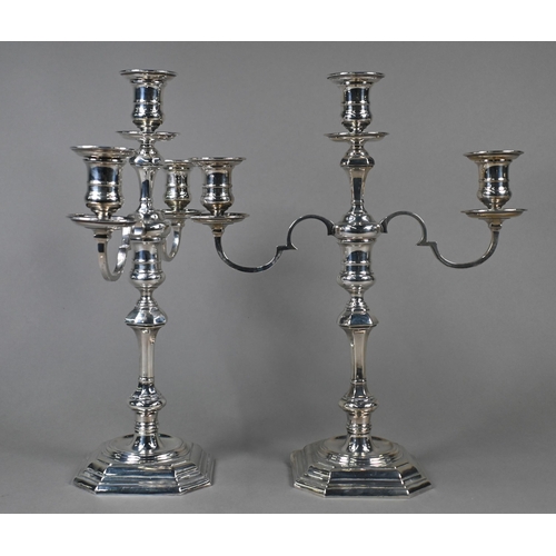 78 - A pair of loaded silver twin-branch candelabra with three sconces and detachable tops, on octagonal ... 