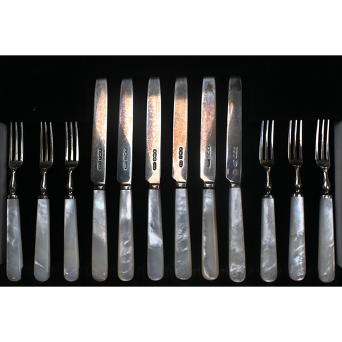 82 - A set of twelve silver dessert knives and forks with mother of pearl handles, C.W. Fletcher & So... 