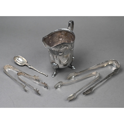 86 - An Irish silver cream jug with Celtic strapwork frieze and hoof feet, Dublin 1914, to/w four pairs o... 