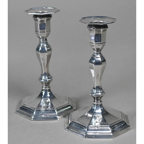 93 - A pair of late Victorian loaded silver candlesticks of octagonal baluster form with detachable greas... 