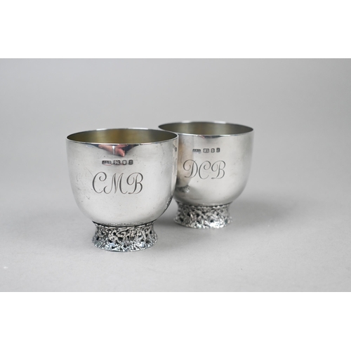 94 - John Donald (1928-2023). A scarce pair of bespoke silver cups, each raised on pierced and textured r... 