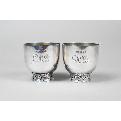 94 - John Donald (1928-2023). A scarce pair of bespoke silver cups, each raised on pierced and textured r... 