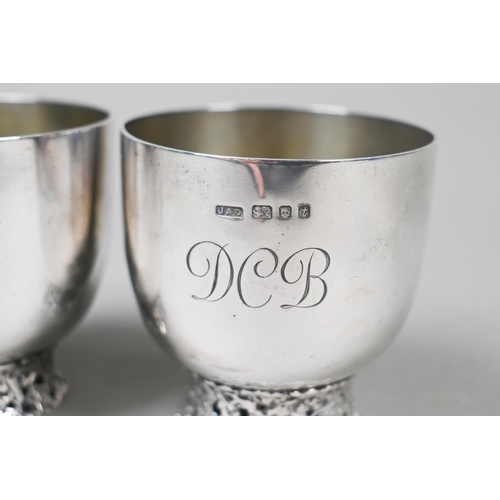 94 - John Donald (1928-2023). A scarce pair of bespoke silver cups, each raised on pierced and textured r... 