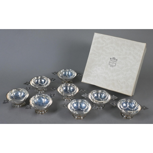 95 - A set of eight Dutch .835 standard bowls, each with cast and pierced twin handles, lobed body and st... 