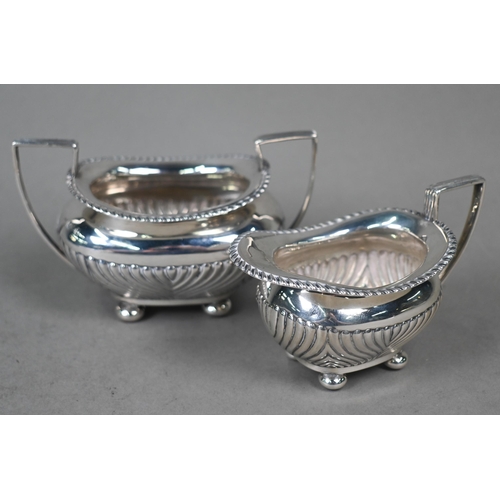 97 - A late Victorian silver half-reeded milk and sugar pair, on bun feet, James Dixon & Son, Sheffie... 