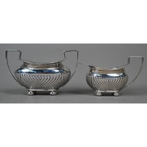 97 - A late Victorian silver half-reeded milk and sugar pair, on bun feet, James Dixon & Son, Sheffie... 