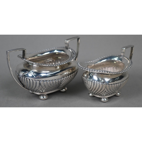 97 - A late Victorian silver half-reeded milk and sugar pair, on bun feet, James Dixon & Son, Sheffie... 