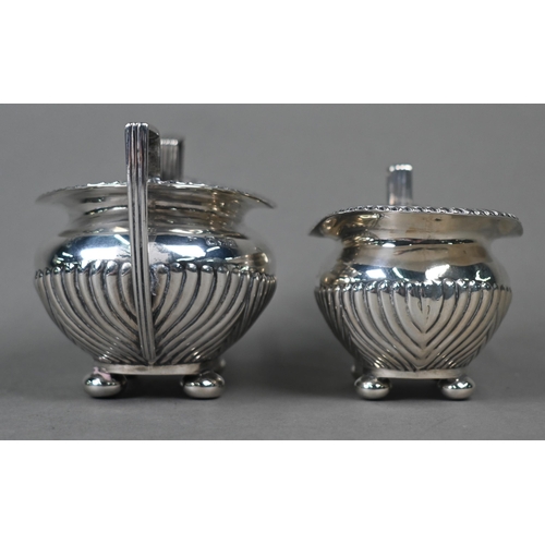 97 - A late Victorian silver half-reeded milk and sugar pair, on bun feet, James Dixon & Son, Sheffie... 