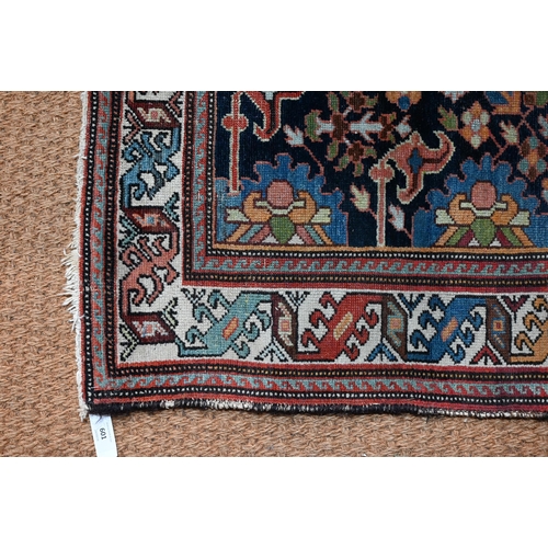 601 - An antique Caucasian blue ground rug, with geometric floral design, 144 cm x 115 cm