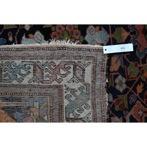 601 - An antique Caucasian blue ground rug, with geometric floral design, 144 cm x 115 cm