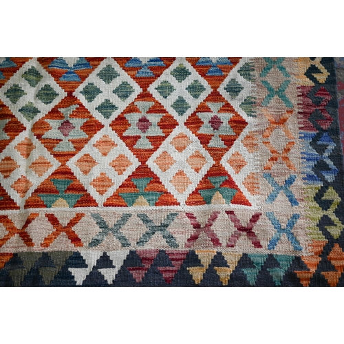 602 - A contemporary Anatolian Kelim, the field of multi-coloured diamond lozenges, 242 cm x 172 cm