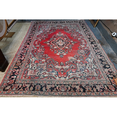 613 - An old Persian Mahal small carpet, the centre floral medallion design on red ground, 306 cm x 214 cm