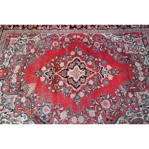 613 - An old Persian Mahal small carpet, the centre floral medallion design on red ground, 306 cm x 214 cm