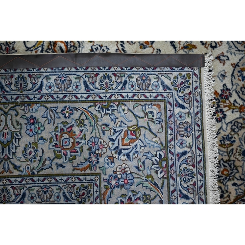 616 - An Indo Persian Kashan carpet, the the camel ground centred by a floral medallion and scrolling flow... 