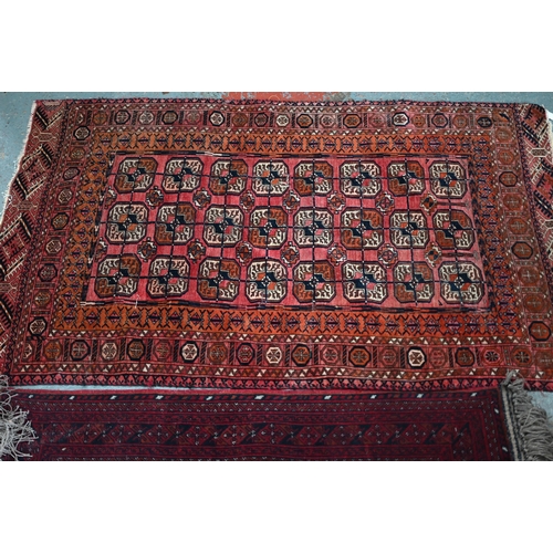 626 - An old Turkoman red ground rug, with three rows of geometric guls, 160 cm x 105 cm to/with a Pakista... 