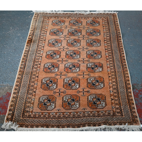 628 - An old golden ground washed Afghan rug, with three rows of stylised guls, 190 cm x 110 cm to/with an... 