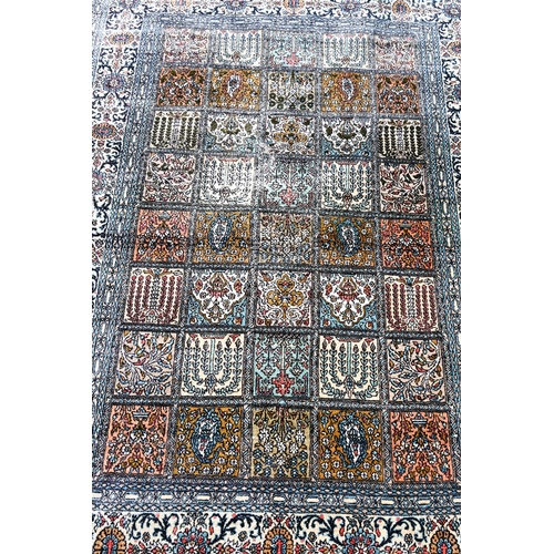 633 - An old Persian Baktiari garden tile design rug in multi-coloured silks, 185 cm x 121 cm