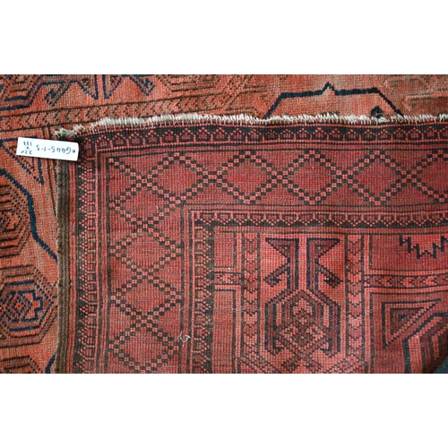 634 - An old Afghan pale red ground lozenge pole design rug, 220 cm x 133 cm, even wear, minor loss to end... 