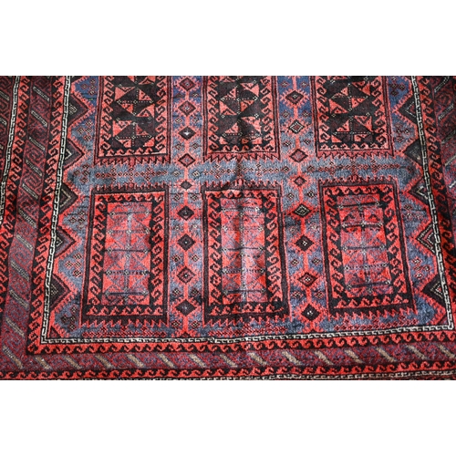 635 - An old Belouch rug, the field with geometric gul design, 190 cm x 150 cm