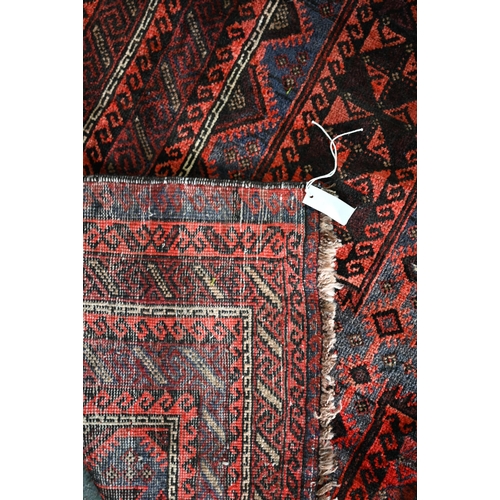 635 - An old Belouch rug, the field with geometric gul design, 190 cm x 150 cm