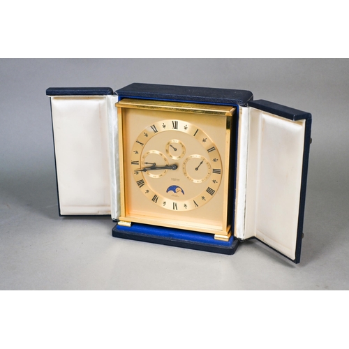 647 - A Swiss antimagnetic 8-day calendar alarm travel clock by Looping, the gilt-brass case with twin win... 