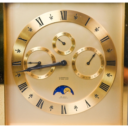 647 - A Swiss antimagnetic 8-day calendar alarm travel clock by Looping, the gilt-brass case with twin win... 