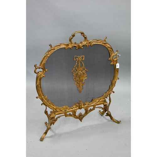 651 - A French rococo style gilt metal framed spark guard, with wire mesh panel on foliate scroll feet, 61... 