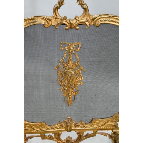 651 - A French rococo style gilt metal framed spark guard, with wire mesh panel on foliate scroll feet, 61... 