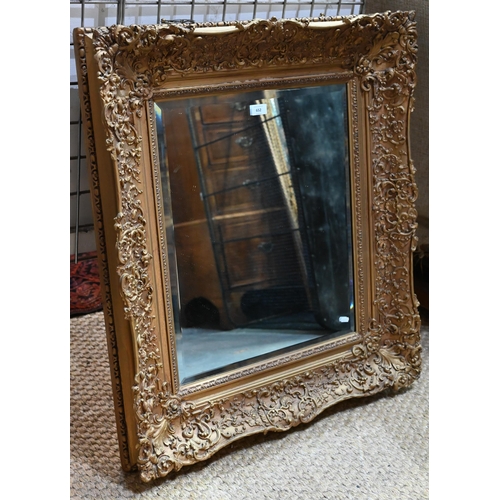 652 - A late 19th century giltwood and composite picture frame, fitted with a bevel edged mirror plate, 80... 