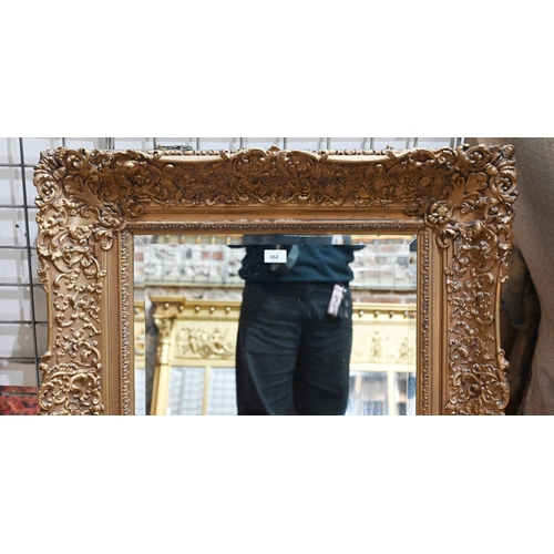 652 - A late 19th century giltwood and composite picture frame, fitted with a bevel edged mirror plate, 80... 