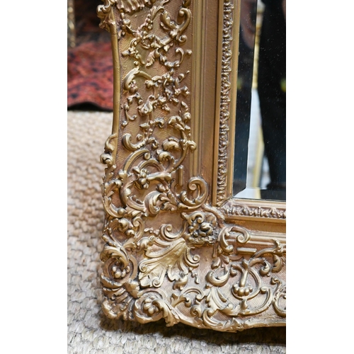 652 - A late 19th century giltwood and composite picture frame, fitted with a bevel edged mirror plate, 80... 