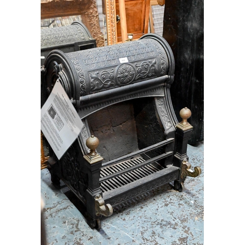 654 - A late Victorian cast iron 'Nautilus' dog-grate fireplace, with brass finials and front mounts, desi... 