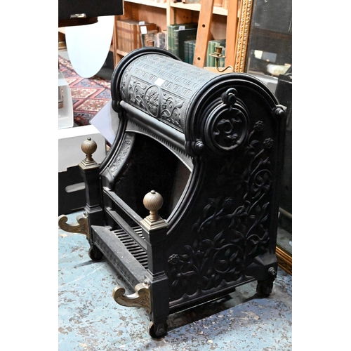 654 - A late Victorian cast iron 'Nautilus' dog-grate fireplace, with brass finials and front mounts, desi... 