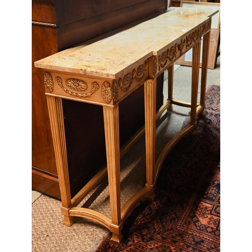 657 - An Adam style breakfront giltwood marble top console table, the frieze with floral swags in relief, ... 